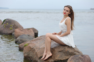 young slender woman by the sea
