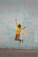 young woman jumps on a blue background
