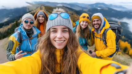 Group of friends hiking in the mountains at sunrise in summer, wearing colorful hiking clothes, smiling and enjoying the view
