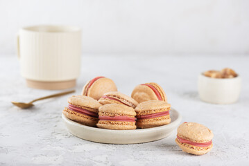 Vegan homemade macaroons with cup of tea on white table. Healthy dessert. Sugar, lactose and gluten free.