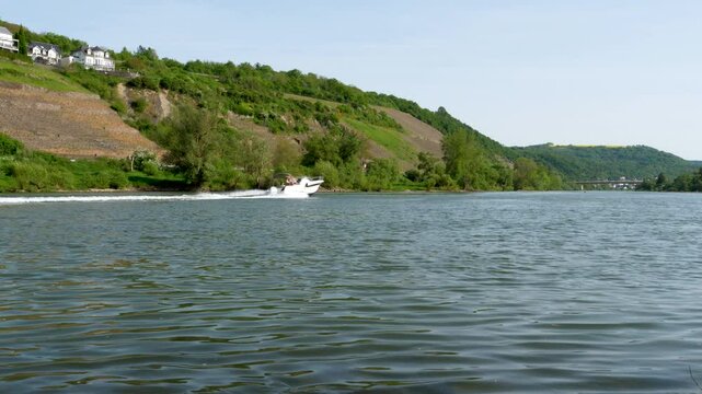 Winningen, Germany - May 02, 2025: Nautical vessel on River Mosel nearby Winningen, Rhineland-Palatinate, Germany. The Moselle is a river that rises in the Vosges mountains and flows through north-eas