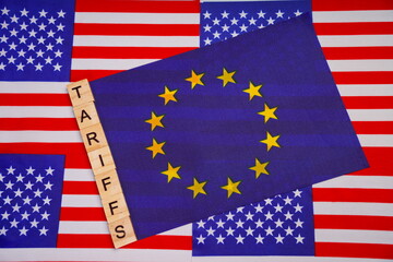 The inscription tariffs on the flag of the European Union, against the background of the flags of the United States.