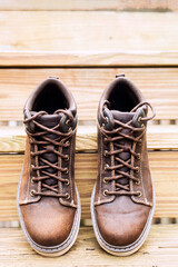 Sturdy leather work boots on a wooden ladder