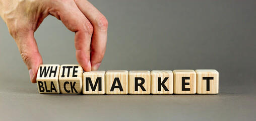 Black or white market symbol. Concept words Black market or White market on beautiful wooden blocks. Beautiful grey background. Businessman hand. Business black or white market concept. Copy space.