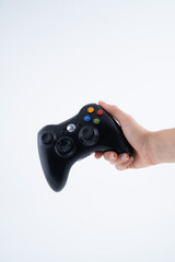 Black Gaming Controller Held in Hand on White Background
