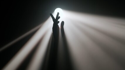 Bright spotlight, professional lighting equipment shining in darkness, hand silhouette playing holding arm up through smoke and light.