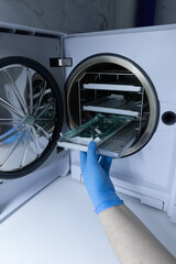 A Technician in Blue Gloves Is Operating a Laboratory Freeze Dryer, Extracting Items from the...
