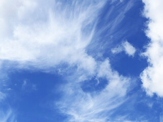 Obraz premium Fluffy white clouds against clear blue sky capturing calmness and natural beauty perfect for tranquil designs and backgrounds