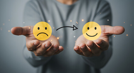 Man Presenting Pixelated Sad Face Transitioning to Happy Face on Gray Background Representing Emotional Growth