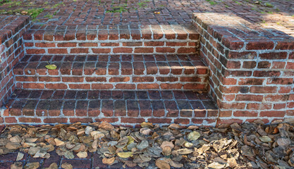 Vintage Faded Red Brick Steps in a Garden.