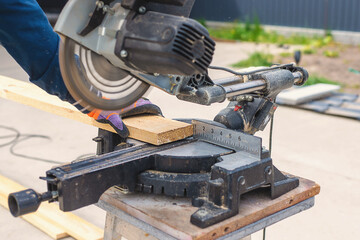 Cutting wood boards man in hands. Selective focus.