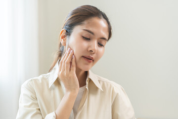Jaw pain, health care concept. Teeth pain and dentistry asian young woman, girl suffering touching her cheek. Female feeling painful toothache. Unhappy feel bad, diseases in oral, ache nerve and molar