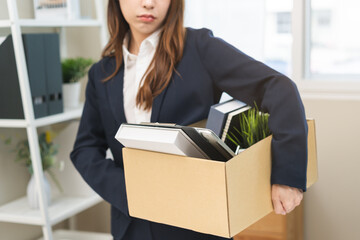 Unemployment, quitting job concept, desperate asian young business woman resigning or fired, leave from company, female holding belongings, stuff into box cardboard, layoff or leaving, changing work.