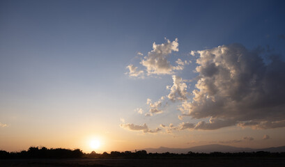 Beautiful sky, sun and cloud at high. Landscape include space, light of nature, sunset, sunrise, horizon or skyline. Colorful with yellow, orange and blue color at evening time for background.