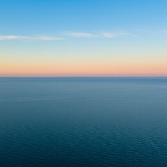 Fototapeta premium Tranquil Ocean Sunset: Pink and Blue Hues over Calm Waters