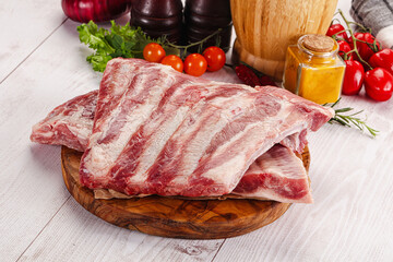 Raw pork ribs over board