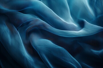 Obraz premium Deep blue sheer fabric draped in soft folds.
