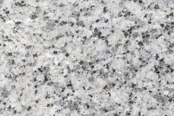 Natural granite surface displaying various gray tones and black specks