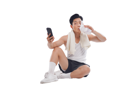 Portrait of muscular Asian man in sportswear sitting posing on white background	
