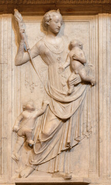 FLORENCE, ITALY - MARCH 17, 2025: The marble relief of Madonna (monument of Ugo II di Toscana) in the church Badia Fiorentina by Mino da Fiesole (1469 - 1481).