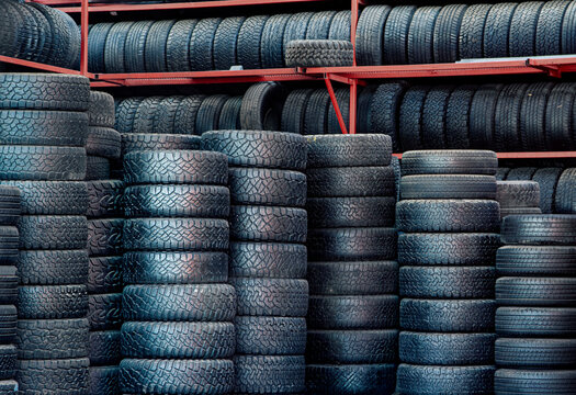 A large group of stacked tires at a tire shop