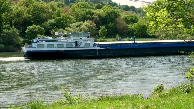 Winningen, Germany - May 02, 2025: Nautical vessel on River Mosel nearby Winningen, Rhineland-Palatinate, Germany. The Moselle is a river that rises in the Vosges mountains and flows through north-eas