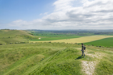 backpacker hiking on sunny day, on the Pewsey Downs, Wiltshire, south of Marlborough, United Kingdom