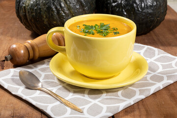 Pumpkin broth on wooden background