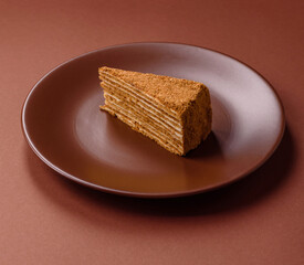 A slice of honey puff cake or pumpkin, carrot and cream pie, vegan sweets