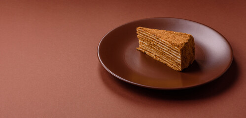 A slice of honey puff cake or pumpkin, carrot and cream pie, vegan sweets