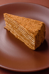 A slice of honey puff cake or pumpkin, carrot and cream pie, vegan sweets