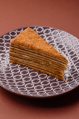 A slice of honey puff cake or pumpkin, carrot and cream pie, vegan sweets