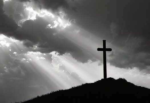 a silhouetted cross stands atop a hill under a dramatic sky filled with stormy clouds and radiant sunbeams.