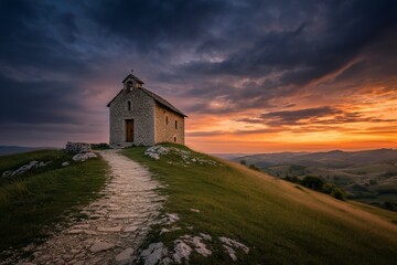 Hilltop Chapel Sunset: A solitary stone chapel stands majestically on a grassy hilltop, silhouetted against a vibrant sunset sky, a path leading gently to its entrance.