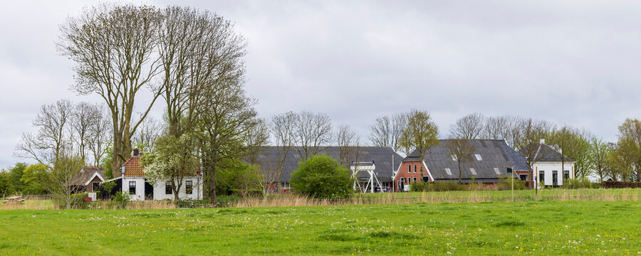 Panoramic vew of Farmhouse surrounded by agricultural field and orchard at estate Verhildersum in Leens The Netherlands
