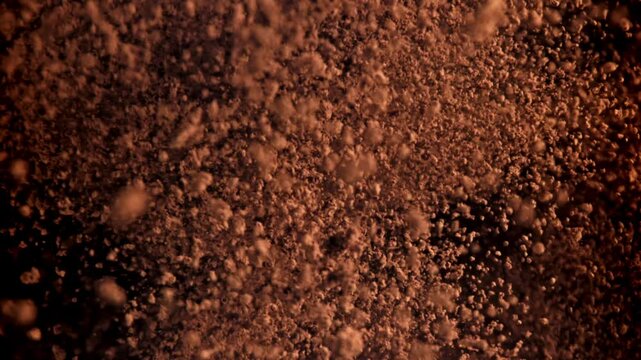 The cocoa powder flies up and down. Filmed on a high-speed camera at 1000 fps. High quality FullHD footage