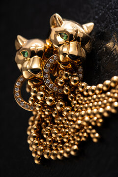 Elegant Cartier Panth&egrave;re earrings crafted in 18kt yellow gold with pav&eacute; diamonds, photographed on a dark background. Milan, Italy. November 26, 2024.