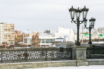 A city street with a row of street lamps on a snowy day in Yekaterenburg Russia