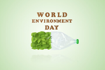 Beat plastic pollution. World Environment day concept. Happy Environment day, 05 June. Plastic bottle and green leaves on a green background. Ecology concept.
