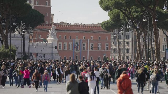 Busy pedestrian street Via dei Fori Imperiali in Rome, blurred view on crowd of unrecognizable walking business and tourist people.