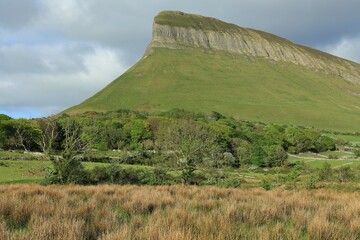 Benbulben Mountain and nearby countryside under overcast sky in springtime. County Sligo, Ireland