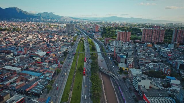 Busy Aerial View of Public Transportation, Cars, and Buildings Along Carrera 30 and TransMilenio Bus Lane - Bogot&aacute;, Colombia