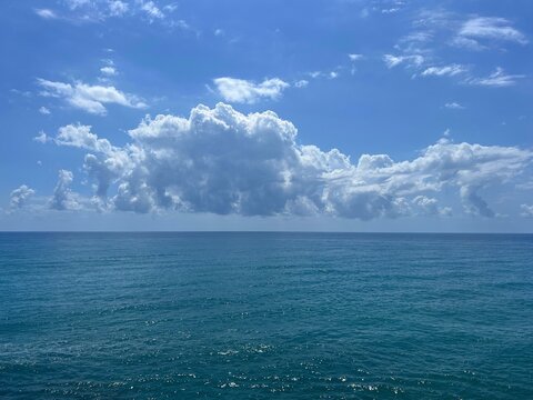 Blue ocean waters and sky beautiful clouds.