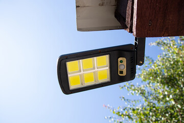 Outdoor LED lamp on the roof of the house, outdoor lighting