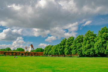Scenic view of bridge over Danube River with historic buildings and blue sky in Ingolstadt, Bavaria, Germany
