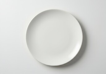 A simple image showcasing a plain white plate centered on a light gray background surface view from above