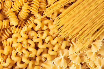 Variety of types and shapes of dry Italian pasta. Layout of Italian raw pasta, top view