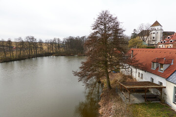 Fototapeta premium Rozmital pod Tremsinem, Czech Republic - March 22, 2025 - the Rozmital Chateau, original mud castle dates back to the mid-13th century on a sunny spring day.