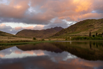 Tranquil Lake Reflecting Mountains at Sunset