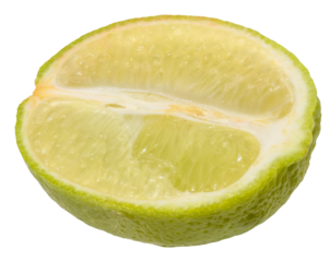 Close-up of a fresh lime wedge with juicy pulp and a bright green peel